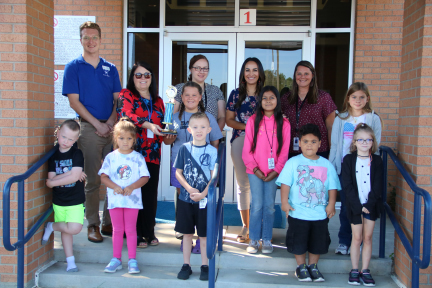 Elementary students with CASA volunteer and admin