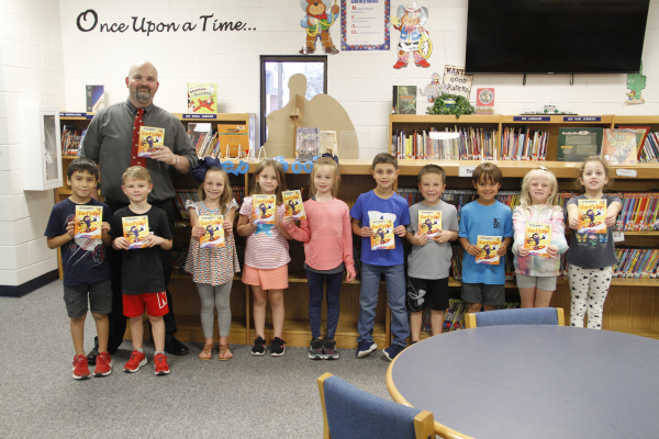 Mr. Pettiette and 1st graders with Luke Flowers book