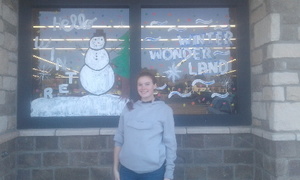 QHS Art Students Paint Brookshire's Windows with Winter Scenes