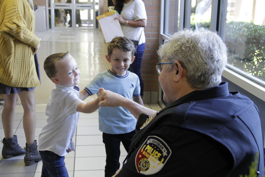 Officer Tucker and Jones pre-k student with friend