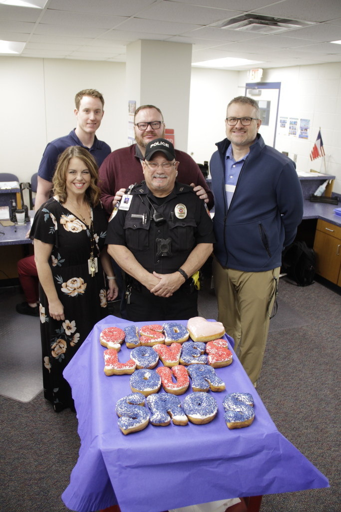 jh/hs principals with officer taylor standing by the donuts